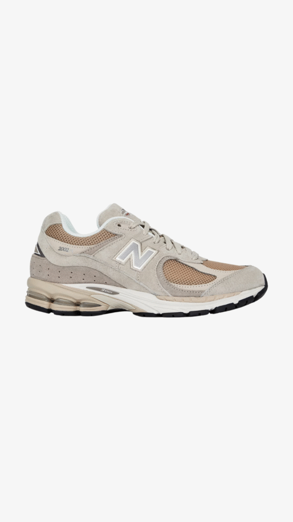 New Balance 2002R suede and mesh sneakers in neutral beige with cushioned sole.