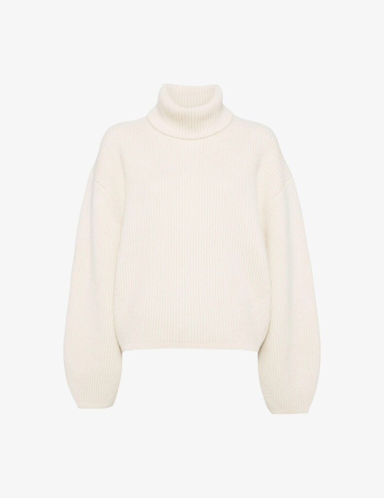 Cream ribbed turtleneck sweater by Totême, sculptural quiet luxury knitwear for minimalist 2026 capsule wardrobes.
