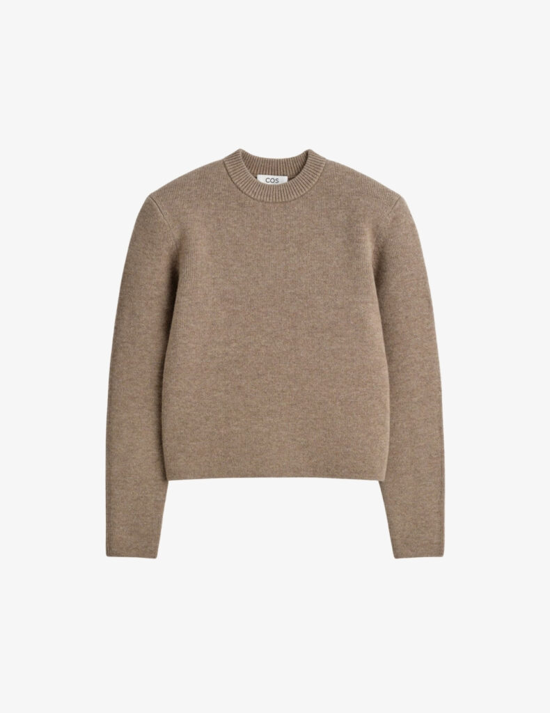 Beige sculpted-shoulder merino wool sweater from COS, minimalist quiet-luxury knit for a refined capsule wardrobe.
