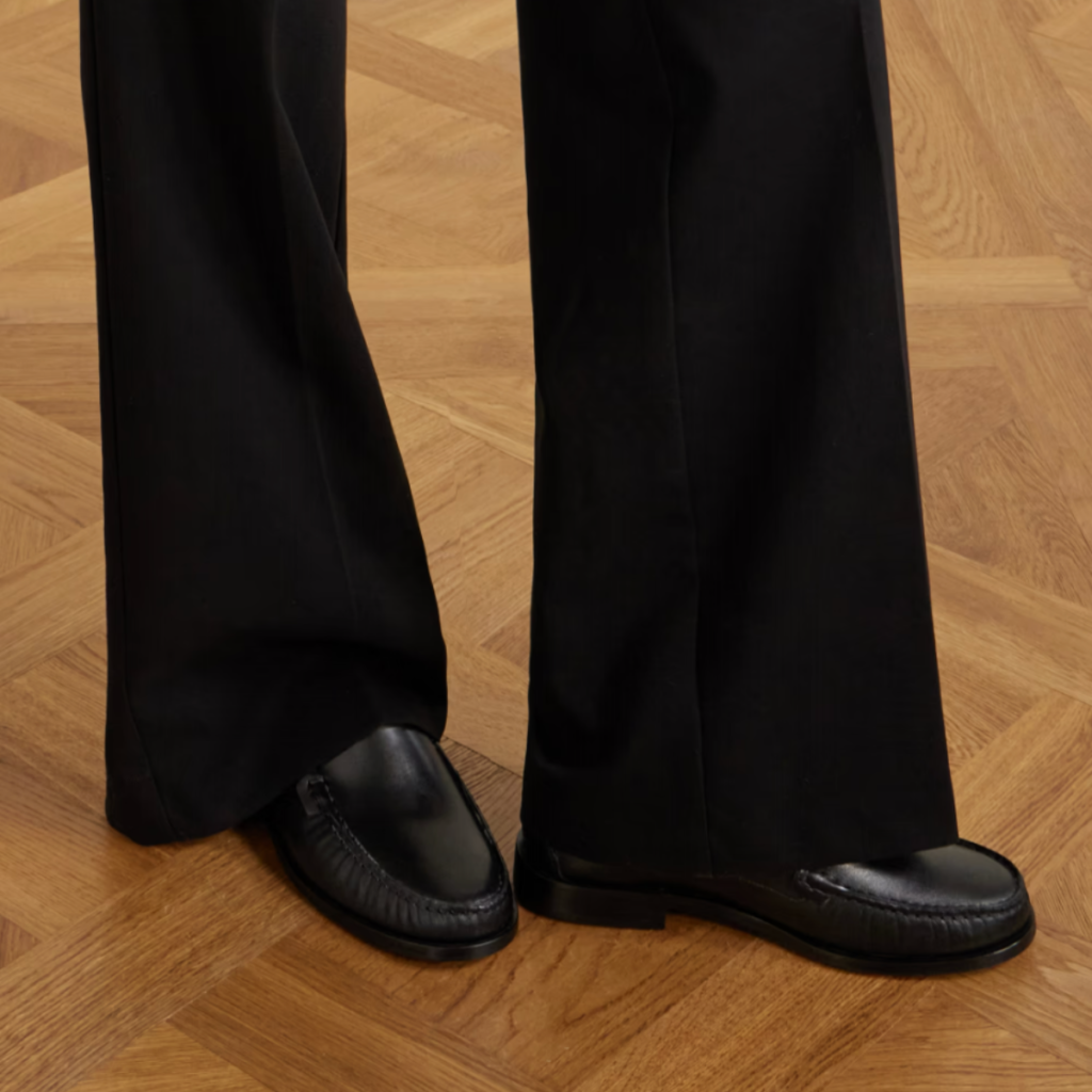 Black Aeyde Arthur leather loafer with a clean penny-loafer silhouette, styled with black tailored trousers