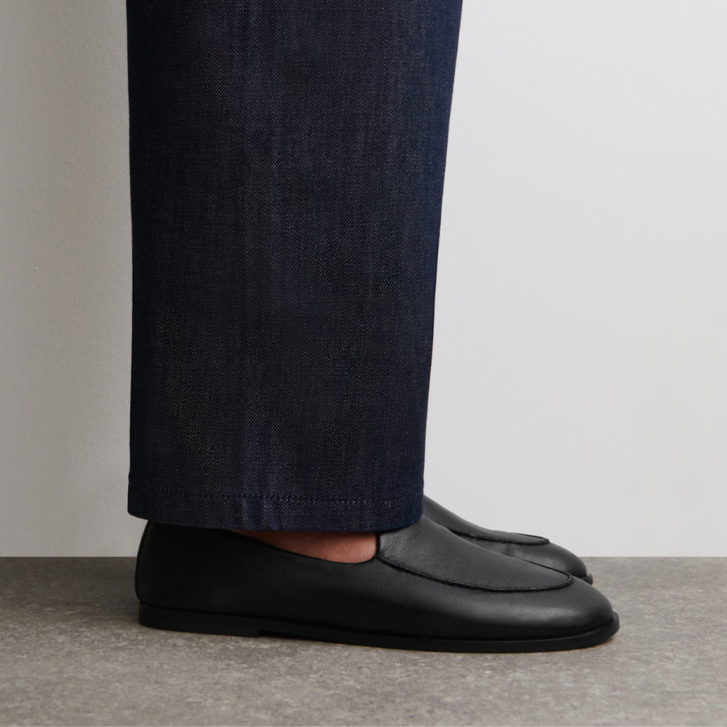 Black COS classic leather loafers worn with dark trousers, minimalist everyday outfit