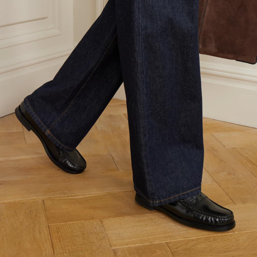 Black Tod’s classic leather penny loafer with smooth leather finish and traditional silhouette