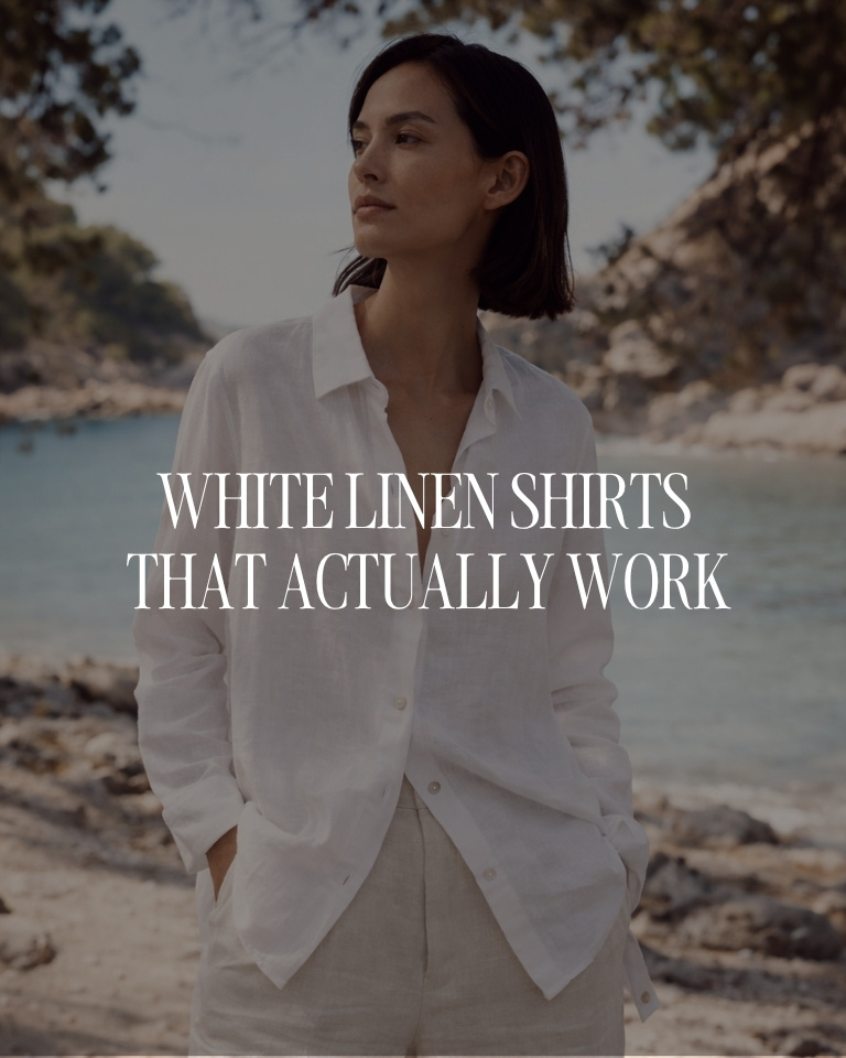 Woman wearing a relaxed white linen shirt and neutral trousers by the sea, styled as part of a minimalist capsule wardrobe.