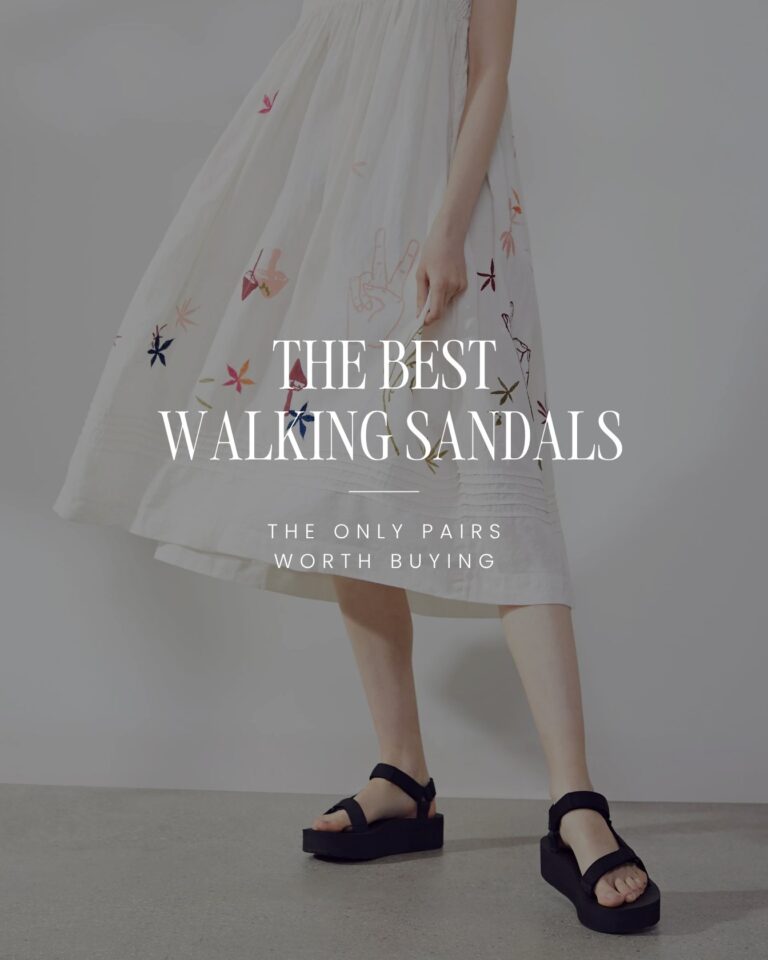 Woman wearing black platform walking sandals with a white summer dress.