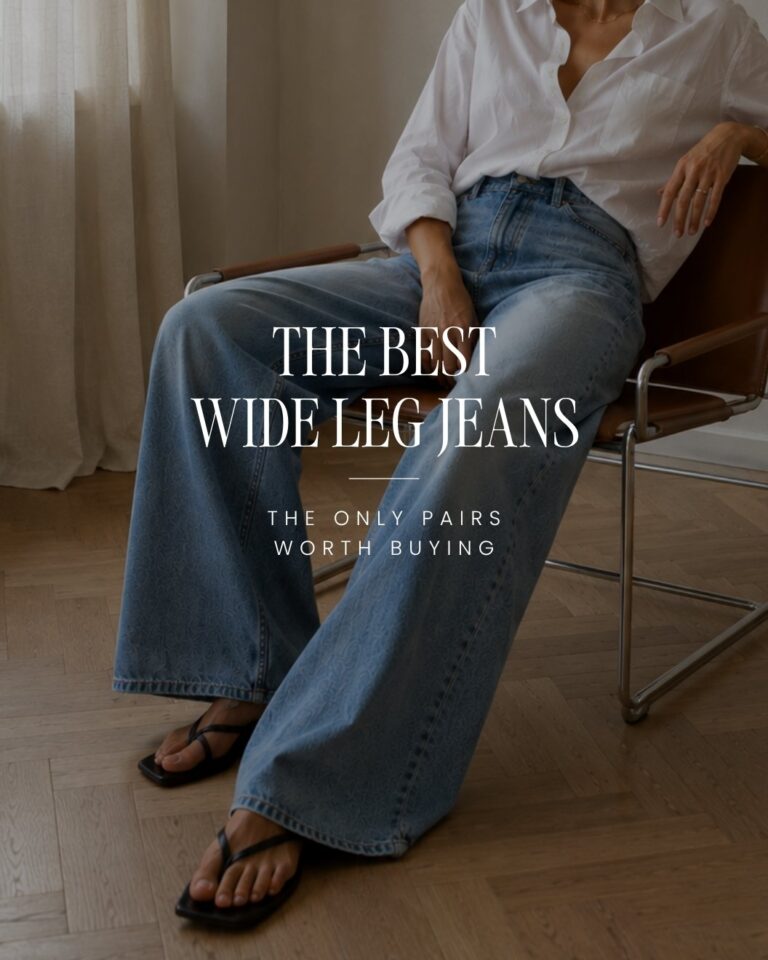 Woman wearing light blue wide leg jeans with a white shirt in a minimalist apartment